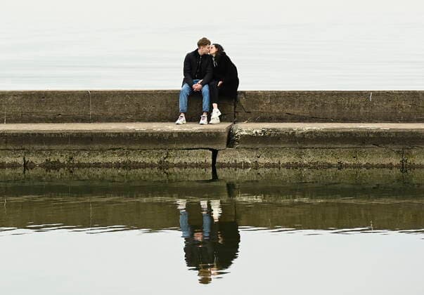 April 5, 2021, Toronto, on, Canada: A couple share a kiss over looking a calm Lake Ontario near Humber Bay during the COVID-19 pandemic in Toronto on Monday, April 5, 2021. Toronto Canada  - ZUMAc35_ 20210405_zaf_c35_039 Copyright: xNathanxDenettex