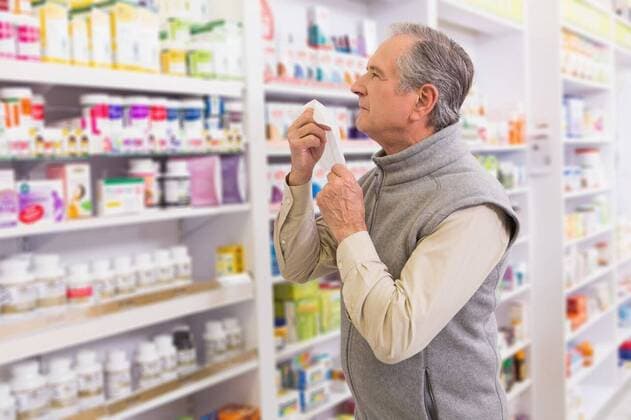 Sick customer holding a tissue Sick customer holding a tissue in the pharmacy, model released, Cape Town, South Africa, 13.09.2014, 443239.jpg, medicine, pharmacy, treatment, care, ill, illness, medical, hospital, clinic, drug, medicament, storage, pharmaceutical, pharmaceutics, drugstore, happy, smiling, cheerful, jar, bottle, prescription, team, grey hair, customer, glass of water, pill, drink, drinking, pain, patient, sick, sickness, symptoms, virus, infection, cold, issue, sneezing, influenza, hay fever, allergies, blowing nose 70s, Senior, Elderly, Man, Male, Caucasian, Senior Men, Caucasian Ethnicity Indoors,Day