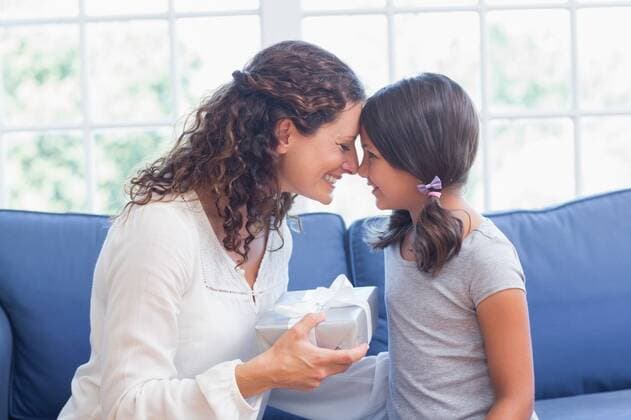 Cute girl offering gift to her mother Cute girl offering gift to her mother in the living room, model released, Cape Town, South Africa, 23.01.2015, 487950.jpg, home, house, household, homey, apartment, domicile, abode, lifestyle, leisure, domestic life, brunette, brown hair, curly hair, couch, sofa, living room, sitting room, casual clothing, relationship, cute, childhood, family with one child, one parent, mother, daughter, pretty, beautiful, family, parent, love, affection, bonding, happy, smiling, cheerful, giving, gift, present, mothers day, birthday 30s, Mid Adult, Woman, Female, Caucasian, Child, Girl, 30-34 Years, Mid Adult Women, Caucasian Ethnicity, 6-7 Years, Girls Indoors,Day