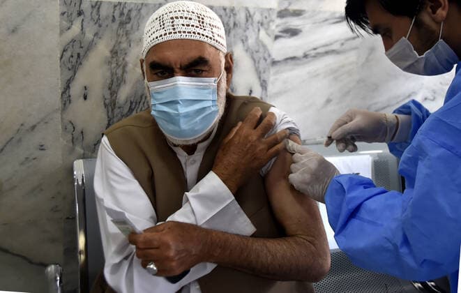 (210408) -- PESHAWAR, April 8, 2021 -- A senior citizen receives a dose of COVID-19 vaccine at a vaccination center in northwest Pakistan s Peshawar on April 7, 2021. So far, more than 1 million people have been vaccinated in Pakistan, and the total number of people who have registered themselves for vaccination is now over 2 million, according to the National Command and Operation Center (NCOC) chief Asad Umar. (Photo by Xinhua) PAKISTAN-COVID-19-VACCINATION SaeedxAhmad 