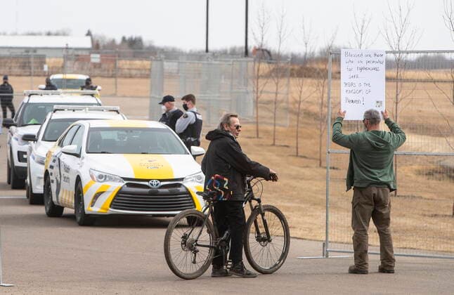 April 7, 2021, EDMONTON, ab, Canada: Supporters gather as a fence is put up around GraceLife Church near Edmonton on Wednesday April 7, 2021. The Alberta government has closed down and fenced off a church that has been charged with refusing to follow COVID-19 health rules. Alberta Health Services, in a statement, says GraceLife church will remain closed until it shows it will comply with public-health measures meant to contain the spread of the novel coronavirus. EDMONTON Canada  - ZUMAc35_ 20210407_zaf_c35_096 Copyright: xJasonxFransonx
