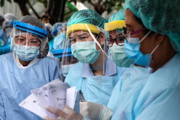 April 8, 2021, Bangkok, Thailand: Health workers prepare documents during a swab test drive outside a nightclub in Bangkok..The Ministry of Public Health is set to recommend the closure of night entertainment spots in high-risk areas of Bangkok, in order to deal with the fast-spreading UK variant of the coronavirus. The UK variant is believed to have played a significant role in the spread of the latest cluster of infections detected at entertainment venues across the capital. Bangkok Thailand - ZUMAs197 20210408_zaa_s197_003 Copyright: xChaiwatxSubprasomx