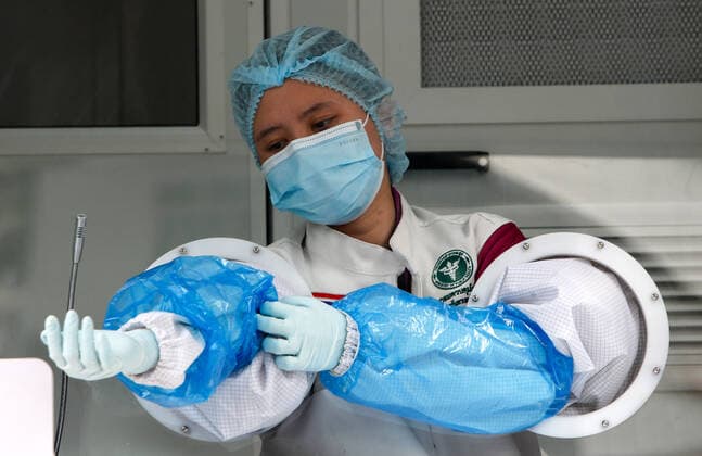 April 8, 2021, Bangkok, Thailand: A health worker gears up before conducting a swab test outside a nightclub in Bangkok..The Ministry of Public Health is set to recommend the closure of night entertainment spots in high-risk areas of Bangkok, in order to deal with the fast-spreading UK variant of the coronavirus. The UK variant is believed to have played a significant role in the spread of the latest cluster of infections detected at entertainment venues across the capital Bangkok Thailand - ZUMAs197 20210408_zaa_s197_007 Copyright: xChaiwatxSubprasomx