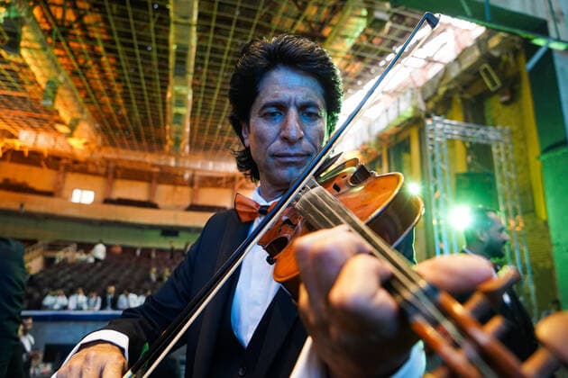 April 8, 2021, Mosul, Nineveh, Iraq: A member of the Watar orchestra playing for the first time on the grounds of the Spring Theatre Hall, which was destroyed during the ISIS occupation in the city..The Watar orchestral includes 36 young men and women from different denominations of Nineveh Governorate, including Muslims, Christians and Yazidis, whose ages range between 8-32 years. Mosul Iraq - ZUMAs197 20210408_zaa_s197_182 Copyright: xIsmaelxAdnanx