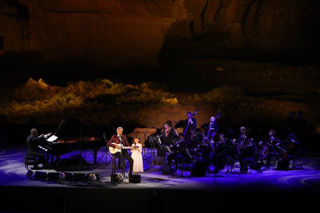 (210409) -- AL ULA, April 9, 2021 -- Italian tenor Andrea Bocelli performs with his daughter Virginia at a concert in Al-Ula, northwestern Saudi Arabia, April 8, 2021. The Italian legendary tenor Andrea Bocelli on Thursday evening performed within the walls of Hegra, Saudi Arabia s first UNESCO World Heritage Site. TO GO WITH Italian tenor Bocelli performs in Saudi s world heritage site ( Handout via Xinhua) SAUDI ARABIA-AL ULA-ANDREA BOCELLI-CONCERT ThexRoyalxCommissionxforxAlUla 