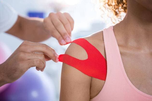 Physiotherapist sticking tape on female patient Physiotherapist sticking tape on female patient in clinic, model released, Cape Town, South Africa, 01.06.2016, 805300.jpg, medical, clinic, hospital, physio, physiotherapy, physiotherapist, orthopedic, physical therapy, therapy, physical therapist, doctor, specialist, profession, professional, patient, casual clothing, sticking, assisting, kinesiotape, kinesiotaping, shoulder, pain, illness, assistance, treatment, cure, recovery, health, health service, bodycare, healthcare, healthcare and medicine, expertise Baby, Girl, Female, Mixed-Race, 30s, Mid Adult, Man, Male, Caucasian, 0-1 Months, Baby Girls, Mixed-Race Person, 30-34 Years, Mid Adult Men, Caucasian Ethnicity Indoors,Close-up