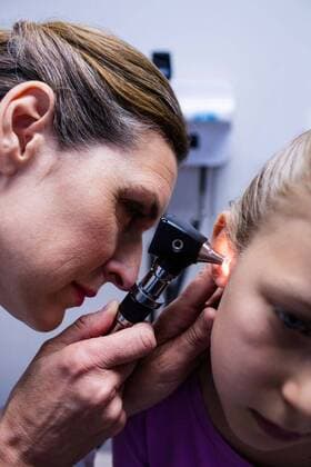 Female doctor examining patient ear with otoscope Female doctor examining patient ear with otoscope in hospital, model released, , property released, Cork, Ireland, 05.11.2016, 877776.jpg, patient, audiologist, otology, doctor, physician, occupation, medical practitioner, specialist, profession, professional, clinical, hospital, medical, clinic, medical office, health service, healthcare and medicine, expertise, laboratory coat, treatment, appointment, medical equipment, medical device, otoscope, medical examination, child, childhood, innocence, cute, adorable, visit, holding, consultation, examining, checking, checkup, analyzing, diagnostic, diagnosis, care, attentive, focused