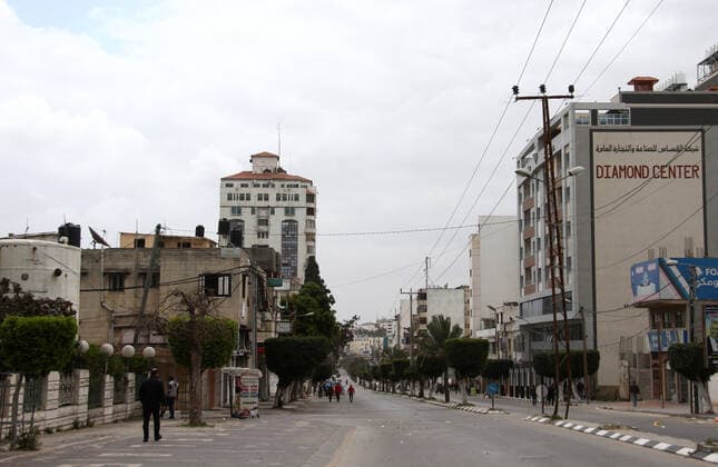 April 10, 2021, Gaza city, Gaza Strip, Palestinian Territory: Paestinians walk at a deserted street is pictured during a lockdown following the outbreak of the coronavirus disease (COVID-19), in Gaza city, on April 10, 2021. New coronavirus cases were down today in the West Bank and Gaza Strip as the death toll remained high. Ministery of Health reported on the disease in Palestine that 438 new cases, 16 deaths, and 812 recoveries were recorded in the West Bank over the last 24 hours, while 1064 new cases, 10 deaths, and 600 recoveries were recorded in the Gaza Strip Gaza city Palestinian Territory - ZUMAap3_ 20210410_zaf_ap3_020 Copyright: xMahmoudxAjjourx