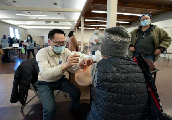 April 10, 2021, Richmond, BC, Canada: Dr. E. Kwok administers a COVID-19 vaccine to a recipient at a vaccination clinic run by Vancouver Coastal Health, in Richmond, B.C., Saturday, April 10, 2021. Richmond Canada  - ZUMAc35_ 20210410_zaf_c35_035 Copyright: xJonathanxHaywardx