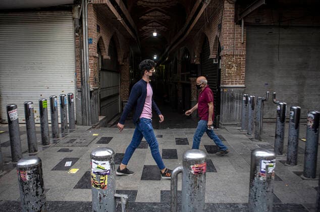 (210410) -- TEHRAN, April 10, 2021 -- People walk past closed shops at the Grand Bazaar in Tehran, Iran, April 10, 2021. Iran on Saturday enforced a 10-day restriction throughout the country to curb the recent resurgence of coronavirus cases and deaths. (Photo by Xinhua) IRAN-TEHRAN-COVID-19-NATIONWIDE RESTRICTIONS-IMPOSED AhmadxHalabisaz 