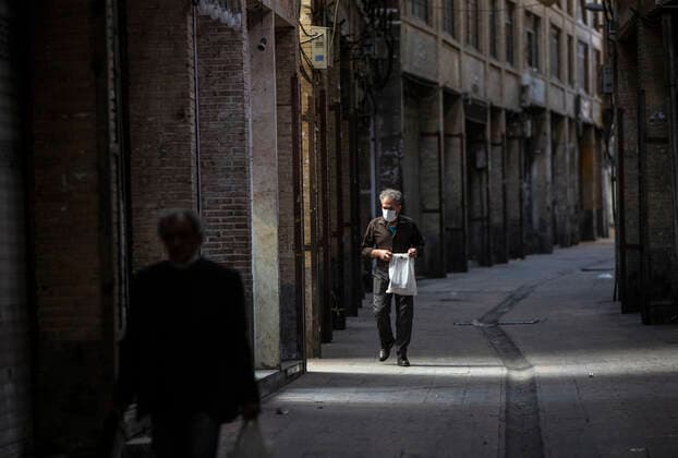 (210410) -- TEHRAN, April 10, 2021 -- People walk past closed shops at the Grand Bazaar in Tehran, Iran, April 10, 2021. Iran on Saturday enforced a 10-day restriction throughout the country to curb the recent resurgence of coronavirus cases and deaths. (Photo by Xinhua) IRAN-TEHRAN-COVID-19-NATIONWIDE RESTRICTIONS-IMPOSED AhmadxHalabisaz 