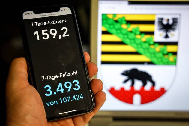 Coronavirus in Germany Covid 19 Dashboard of the Robert Koch Institute DEU, Germany, Saxony Anhalt, 11 04 2021 The 7-day incidence for the state Cases last 7 days 100 000 PE is displayed on an iPhone, with the state coat of arms in the background.