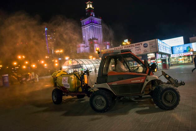 April 11, 2021, Warsaw, Poland: A special vehicle towing a trailer with tank is seen disinfecting along the square in Warsaw s center..At night, the municipal cleaning services disinfect the most important and most frequently used communication routes in the center of Warsaw. Disinfection was carried out with highly ozonated water - it is an innovative Polish method..Disinfection of Warsaw was performed due to the covid 19 pandemic, the third wave of the virus is currently raging in Poland, there is a shortage of places in hospitals and the average daily number of new cases is around 30,000, while deaths are over 600. Warsaw Poland - ZUMAs197 20210411_zaa_s197_001 Copyright: xAttilaxHusejnowx