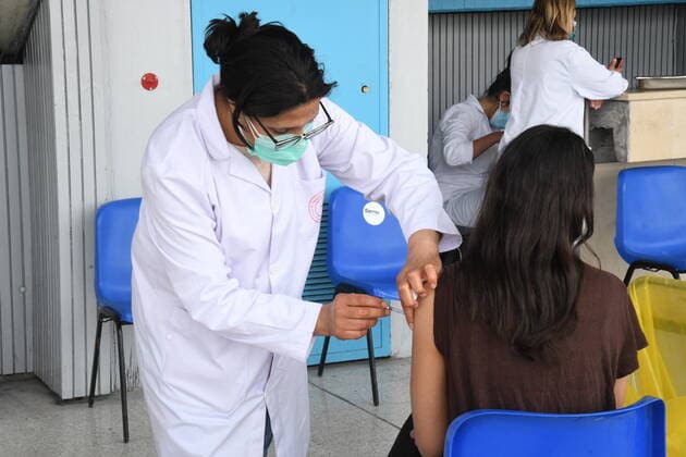 (210411) -- TUNIS, April 11, 2021 -- A woman receives a dose of COVID-19 vaccine at a vaccination center in a gymnasium in Tunis, Tunisia, April 10, 2010. (Photo by Xinhua) TUNISIA-TUNIS-COVID-19-VACCINATION AdelxEzzine 