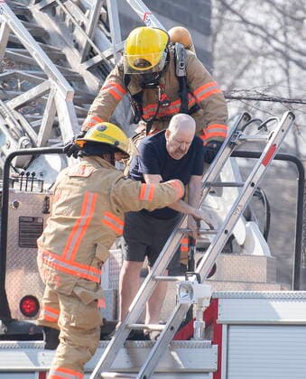 April 11, 2021, Montreal, PQ, Canada: Firefighters help a man out of a seniors residence following a fire in Montreal, Sunday, April 11, 2021. Montreal Canada  - ZUMAc35_ 20210411_zaf_c35_001 Copyright: xGrahamxHughesx