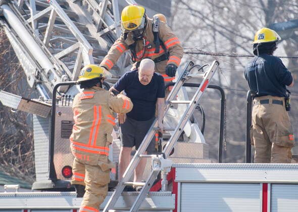 April 11, 2021, Montreal, PQ, Canada: Firefighters help a man out of a seniors residence following a fire in Montreal, Sunday, April 11, 2021. Montreal Canada  - ZUMAc35_ 20210411_zaf_c35_003 Copyright: xGrahamxHughesx