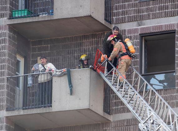 April 11, 2021, Montreal, PQ, Canada: Firefighters help people out of a seniors residence following a fire in Montreal, Sunday, April 11, 2021. Montreal Canada  - ZUMAc35_ 20210411_zaf_c35_004 Copyright: xGrahamxHughesx