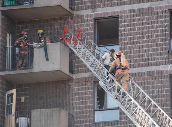 April 11, 2021, Montreal, PQ, Canada: Firefighters help a man out of a seniors residence following a fire in Montreal, Sunday, April 11, 2021. Montreal Canada  - ZUMAc35_ 20210411_zaf_c35_005 Copyright: xGrahamxHughesx