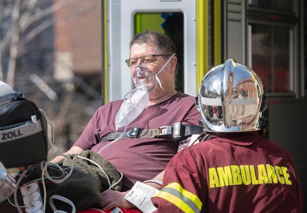 April 11, 2021, Montreal, PQ, Canada: A man is placed into an ambulance following a fire at an apartment building in Montreal, Sunday, April 11, 2021. Montreal Canada  - ZUMAc35_ 20210411_zaf_c35_010 Copyright: xGrahamxHughesx