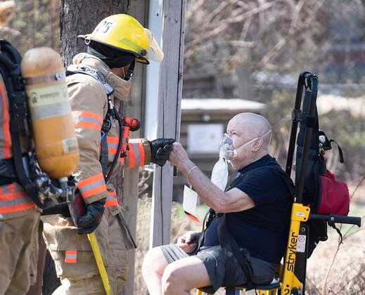 April 11, 2021, Montreal, PQ, Canada: A man fists pumps a firefighter after he was removed from an apartment building following a fire in Montreal, Sunday, April 11, 2021. Montreal Canada  - ZUMAc35_ 20210411_zaf_c35_013 Copyright: xGrahamxHughesx