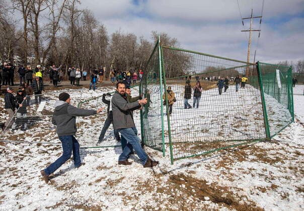 April 11, 2021, EDMONTON, ab, Canada: Supporters tear down a fence around GraceLife Church near Edmonton, Alta., on Sunday, April 11, 2021. The church has been fenced off by police and Alberta Health Services in violation of COVID-19 rules. EDMONTON Canada  - ZUMAc35_ 20210411_zaf_c35_042 Copyright: xJasonxFransonx