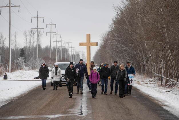 April 11, 2021, EDMONTON, ab, Canada: GraceLife Church supporters carry a cross down the road as they gather near Edmonton, Alta., on Sunday, April 11, 2021. The church has been fenced off by police and Alberta Health Services in violation of COVID-19 rules. EDMONTON Canada  - ZUMAc35_ 20210411_zaf_c35_048 Copyright: xJasonxFransonx