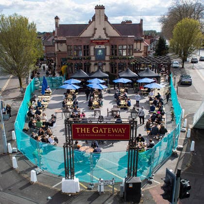 People drink outside the JD Wetherspoon Gateway pub in East Didsbury, south Manchester on 12 April 2021. Customers have returned to the High Street on Monday as non-essential retailers in England and Wales reopened after more than three months of lockdown restrictions due to the Covid-19 pandemic. Manchester Greater Manchester England City centre  Copyright: xMattxWilkinsonx
