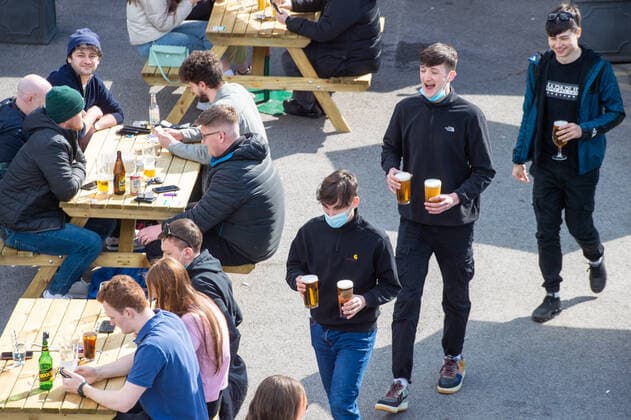 Three young men walk in to the beer garden at the JD Wetherspoon Gateway pub in East Didsbury, south Manchester on 12 April 2021. Customers have returned to the High Street on Monday as non-essential retailers in England and Wales reopened after more than three months of lockdown restrictions due to the Covid-19 pandemic. Manchester Greater Manchester England City centre  Copyright: xMattxWilkinsonx