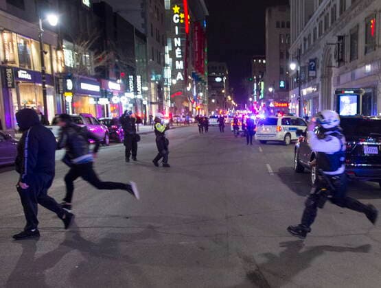 April 12, 2021, Montreal, PQ, Canada: A police officer chases a protester across Saint Catherine street 7as anti-curfew protests continue for a second night Monday, April 12, 2021 in Montreal. Montreal Canada  - ZUMAc35_ 20210412_zaf_c35_097 Copyright: xRyanxRemiorzx