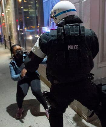 April 12, 2021, Montreal, PQ, Canada: Police try and detain a woman as anti-curfew protests continue for a second night Monday, April 12, 2021 in Montreal. Montreal Canada  - ZUMAc35_ 20210412_zaf_c35_101 Copyright: xRyanxRemiorzx