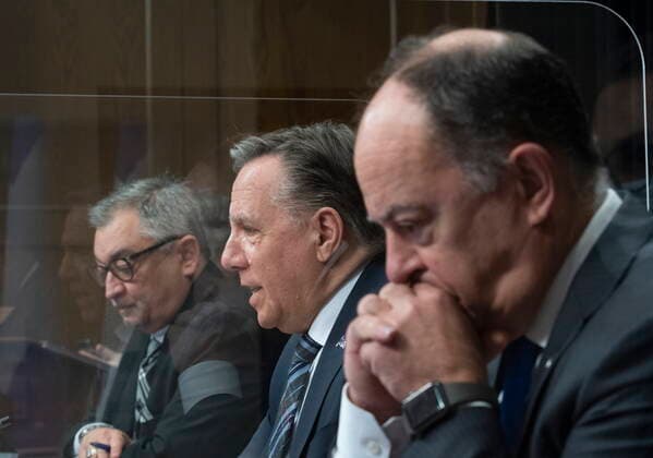 April 13, 2021, QUEBEC, PQ, Canada: Quebec Premier Francois Legault, centre, speaks during a news conference on the COVID-19 pandemic, Tuesday, April 13, 2021 at the legislature in Quebec City. Legault is flanked by Horacio Arruda, Quebec director of National Public Health, left, and Quebec Health Minister Christian Dube. QUEBEC Canada - ZUMAc35_ 20210413_zaf_c35_048 Copyright: xJacquesxBoissinotx
