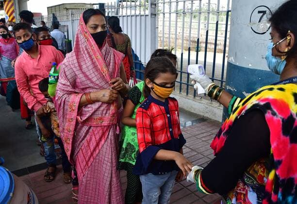 MUMBAI, INDIA APRIL 13: Travellers undergo thermal screening at Dadar Railway Station, on April 13, 2021 in Mumbai, India. (Photo by Bhushan KoyandeHindustan Times ) Migrant Workers Return To Their Native Place Amid Fears Of A Total Lockdown