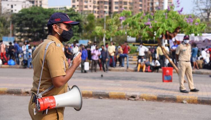 MUMBAI, INDIA APRIL 13: A Police personnel speaks on a loudspeaker at Lokmanya Tilak Terminus, at Kurla, on April 13, 2021 in Mumbai, India. (Photo by Vijay Bate Hindustan Times ) Migrant Workers Return To Their Native Place Amid Fears Of A Total Lockdown