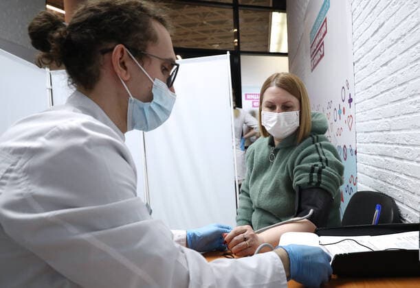 MOSCOW, RUSSIA â€“ APRIL 14, 2021: A woman undergoes medical examination at a mobile COVID-19 vaccination site at the Arena Plaza shopping mall where the Gam-COVID-Vac vaccine (under the brand name of Sputnik V) is provided free of charge and without prior sign-up. Mikhail Tereshchenko TASS  TS0FCBB0