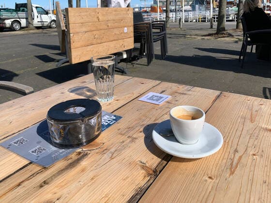 QR code on a table at a sidewalk cafe in Kiel to register via Luca app because of corona restrictions