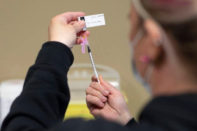 April 15, 2021, Saskatoon, SK, Canada: A RN draws the vaccine into a syringe at the Saskatoon Tribal Council run vaccination clinic inside SaskTel centre in Saskatoon, Sask., on Thursday, April 15, 2021. Saskatoon Canada  - ZUMAc35_ 20210415_zaf_c35_053 Copyright: xKaylexNeisx