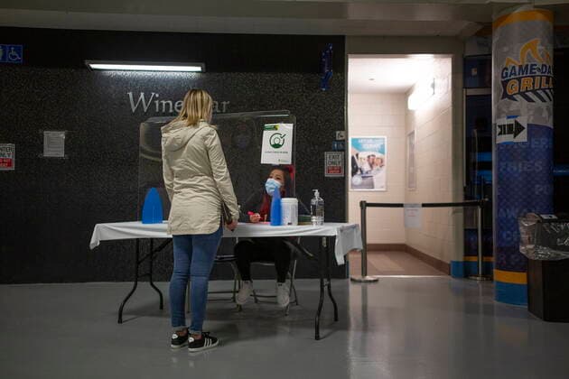 April 15, 2021, Saskatoon, SK, Canada: A patient goes through a check point before getting vaccinated at the Saskatoon Tribal Council run vaccination clinic inside SaskTel centre in Saskatoon, Sask., on Thursday, April 15, 2021. Saskatoon Canada  - ZUMAc35_ 20210415_zaf_c35_061 Copyright: xKaylexNeisx