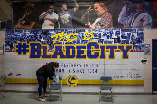 April 15, 2021, Saskatoon, SK, Canada: A volunteer from STC cleans off the chairs where patients wait after receiving the vaccine at the Saskatoon Tribal Council run vaccination clinic inside SaskTel centre in Saskatoon, Sask., on Thursday, April 15, 2021. Saskatoon Canada  - ZUMAc35_ 20210415_zaf_c35_067 Copyright: xKaylexNeisx