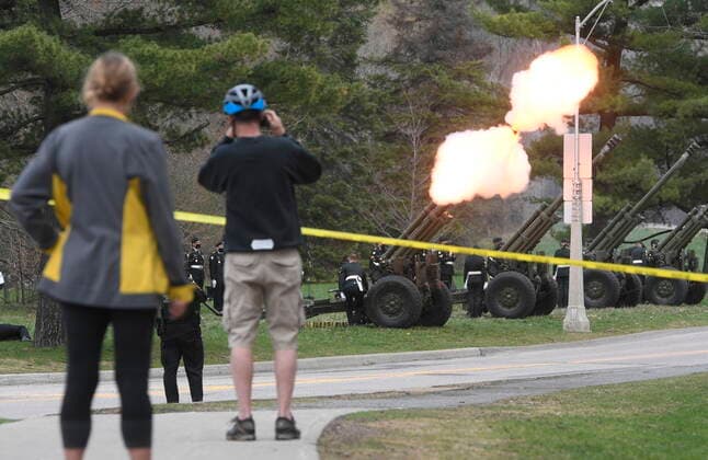 April 17, 2021, Ottawa, on, Canada: Cyclists stop to watch as members of the 30th Field Artillery Regiment, Royal Canadian Artillery conduct a gun salute near Rideau Hall in Ottawa, Saturday April 17,2021. The salute consisted of 41 blank rounds to honour of Prince Philip, The Duke of Edinburgh, who recently passed away. Ottawa Canada  - ZUMAc35_ 20210417_zaf_c35_021 Copyright: xAdrianxWyldx