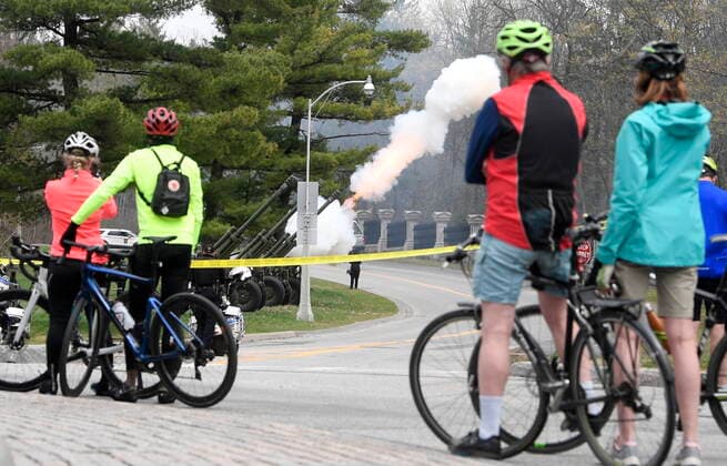 April 17, 2021, Ottawa, on, Canada: Cyclists stop to watch as members of the 30th Field Artillery Regiment, Royal Canadian Artillery conduct a gun salute near Rideau Hall in Ottawa, Saturday April 17,2021. The salute consisted of 41 blank rounds to honour of Prince Philip, The Duke of Edinburgh, who recently passed away. Ottawa Canada  - ZUMAc35_ 20210417_zaf_c35_022 Copyright: xAdrianxWyldx
