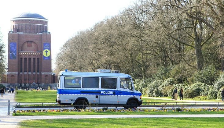 A police squad car patrols Hamburgs city park In Hamburgs parks, masks are compulsory at certain times during the weekend Winterhude Hamburg