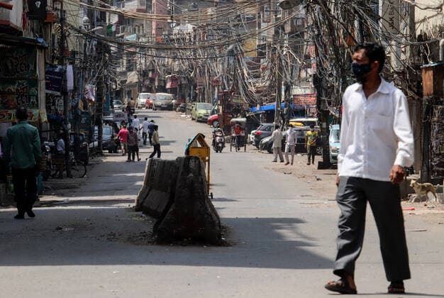 April 18, 2021, New Delhi, India: A man wearing face mask walks on the deserted road at Sadar Bazar wholesale market during the weekend lockdown imposed by the State government to curb the spike of coronavirus (Covid-19) cases. .Only essential services will be exempted from the lockdown, India reported 264,500 new Covid-19 infection cases, 1,501 deaths and 138,423 discharges in last 24 hours. New Delhi India - ZUMAs197 20210418_zaa_s197_058 Copyright: xNaveenxSharmax