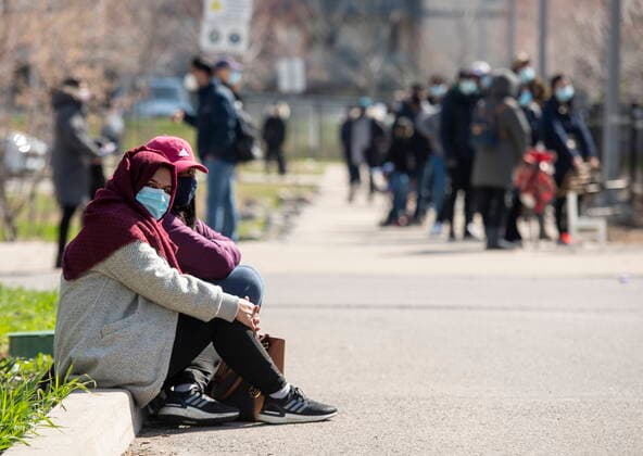 April 19, 2021, Toronto, on, Canada: Two women take a break from the line-up at a mobile COVID19 vaccine clinic at Parkway Forest Community Centre in Toronto on Monday, April 19, 2021. Toronto Canada  - ZUMAc35_ 20210419_zaf_c35_053 Copyright: xFrankxGunnx