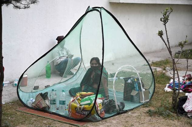 COVID-19 outbreak in India Family members of covid patients rest outside a government hospital in Prayagraj. Allahabad Uttar Pradesh India Copyright: PrabhatxKumarxVerma