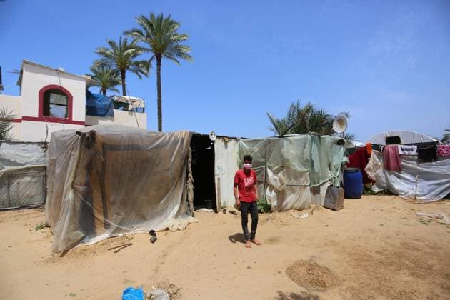 April 21, 2021, Deir Al-Balah, Gaza Strip, Palestinian Territory: Palestinian woman Zohra Abu Shaer, mother of 13 child, sits with her husband inside their dwelling in Deir Al-Balah camp in the central Gaza Strip on April 21, 2021. More than two-thirds of the Gaza Strip™s population of some 2 million people suffers from poverty or extreme poverty, according to the UN Relief and Works Agency for Palestine Refugees (UNRWA Deir Al-Balah Palestinian Territory - ZUMAap3_ 20210421_zaf_ap3_204 Copyright: xAshrafxAmrax