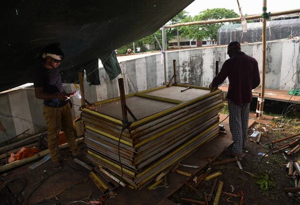 April 21, 2021, Guwahati, Assam, India: Workers making beds for a COVID-19 treatment facility newly set up, at Sarusajai Sports Complex. India has reported 2,95,041 new COVID19 cases, 2,023 deaths and 1,67,457 discharges in the last 24 hours, Union Health Ministry said. Guwahati India - ZUMAt232 20210421_zip_t232_011 Copyright: xDavidxTalukdarx