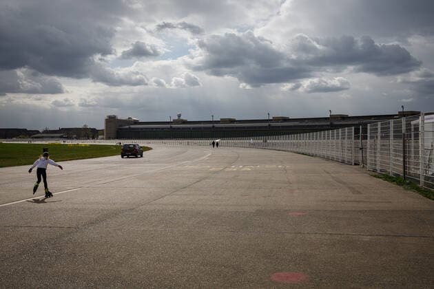 Skater on the Tempelhofer Feld Berlin Roller Skater on the Tempelhofer Feld with thunderclouds in the background