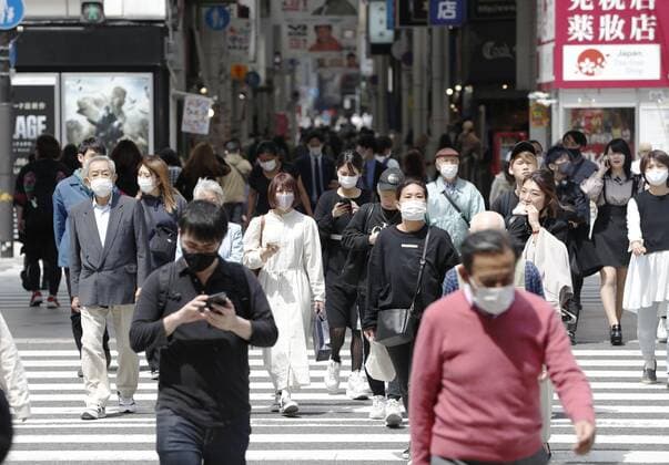 COVID-19 state of emergency declared for Tokyo, Osaka region People wearing face masks walk in Osaka s Minami area on April 23, 2021. Prime Minister Yoshihide Suga declared a state of emergency the same day in Tokyo and the western Japan prefectures of Osaka, Kyoto and Hyogo amid a rapid resurgence of coronavirus infections. 