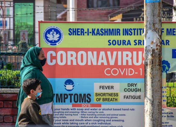 April 23, 2021, Srinagar, India: A woman with her kid wearing masks as a preventive measure against the spread of covid-19 walk along the Streets following the second wave of Coronavirus in Srinagar..India reported the world s highest daily tally of coronavirus infections for a second day on Friday, surpassing 330,000 new cases and 2256 deaths in the past 24 hours. Srinagar India - ZUMAs197 20210423_zaa_s197_311 Copyright: xSaqibxMajeedx