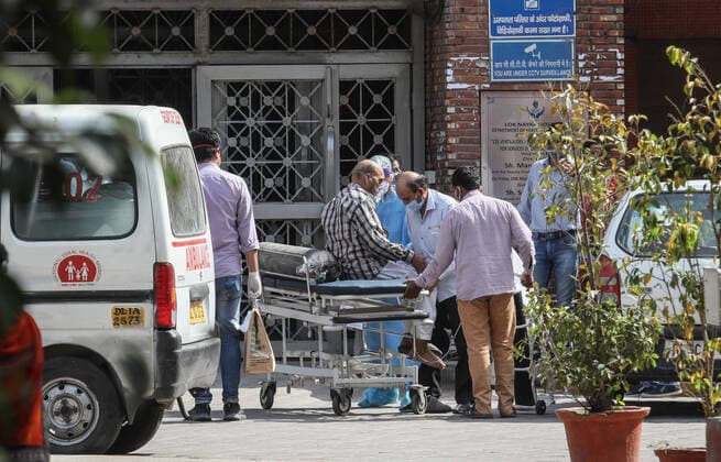 April 23, 2021, New Delhi, India: Relatives help a Covid-19 suspected patient brought at Lok Nayak Jai Prakash (LNJP) Hospital in Old Delhi..India is running out of oxygen during the second wave of Covid-19 pandemic. India has recorded 332,730 new Covid-19 cases in a single day and 2,263 deaths in the last one day. New Delhi India - ZUMAs197 20210423_zaa_s197_321 Copyright: xNaveenxSharmax